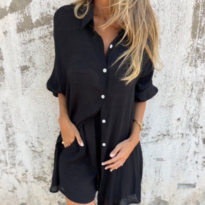 A woman wearing a buttoned polo top with matching flowing shorts