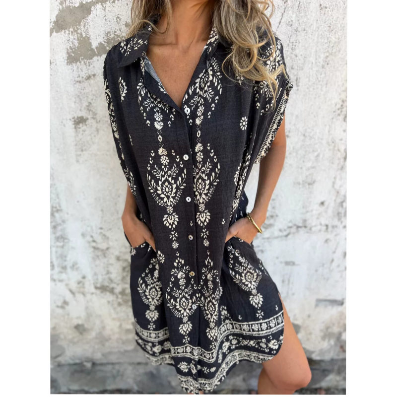 Woman wearing the Edith vintage print shirt dress with a button front and soft collar, standing in warm daylight.