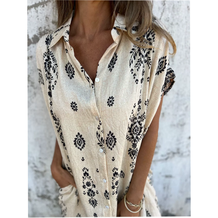 Woman wearing the Edith vintage print shirt dress with a button front and soft collar, standing in warm daylight.