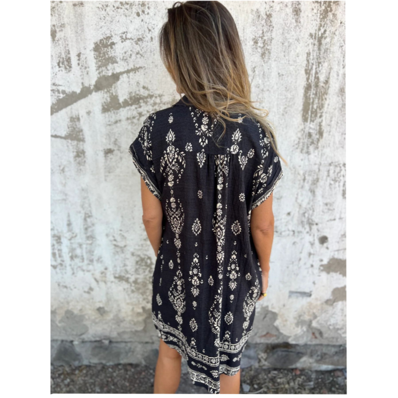Woman wearing the Edith vintage print shirt dress with a button front and soft collar, standing in warm daylight.