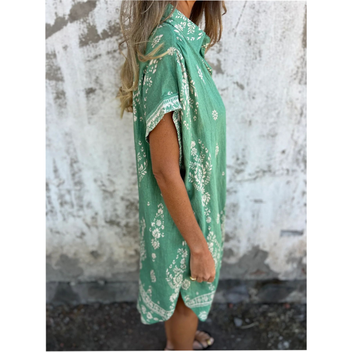 Woman wearing the Edith vintage print shirt dress with a button front and soft collar, standing in warm daylight.
