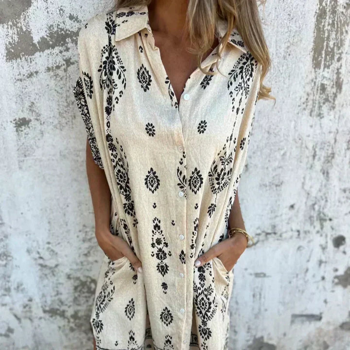 Woman wearing the Edith vintage print shirt dress with a button front and soft collar, standing in warm daylight.