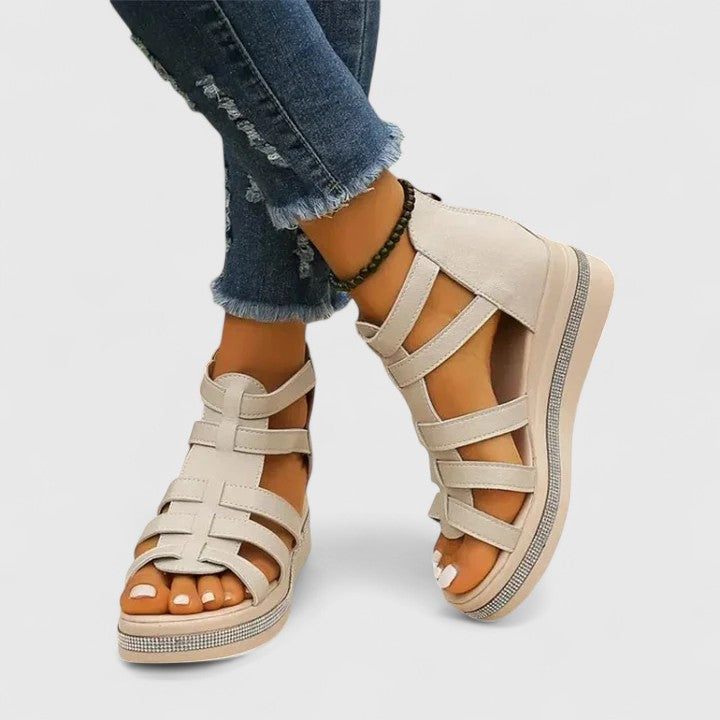 A woman in black strappy sandals walking confidently on a summer day, feet relaxed and supported.