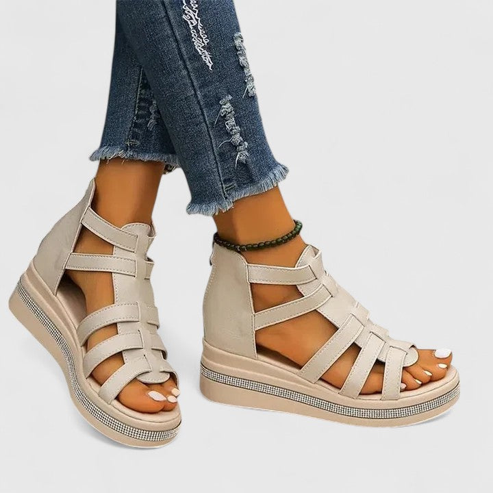 A woman in black strappy sandals walking confidently on a summer day, feet relaxed and supported.