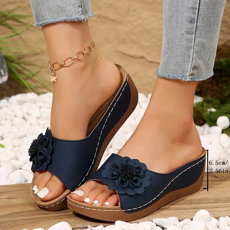 Beige wedge sandals with a delicate floral detail on the strap