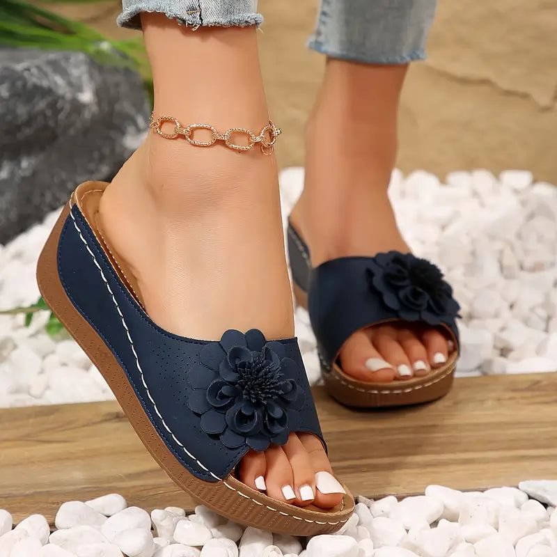 Beige wedge sandals with a delicate floral detail on the strap