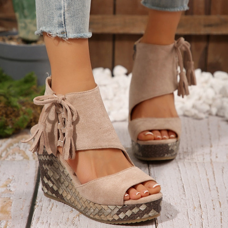 Boho wedge sandals in khaki with a trailing fringe detail at the back