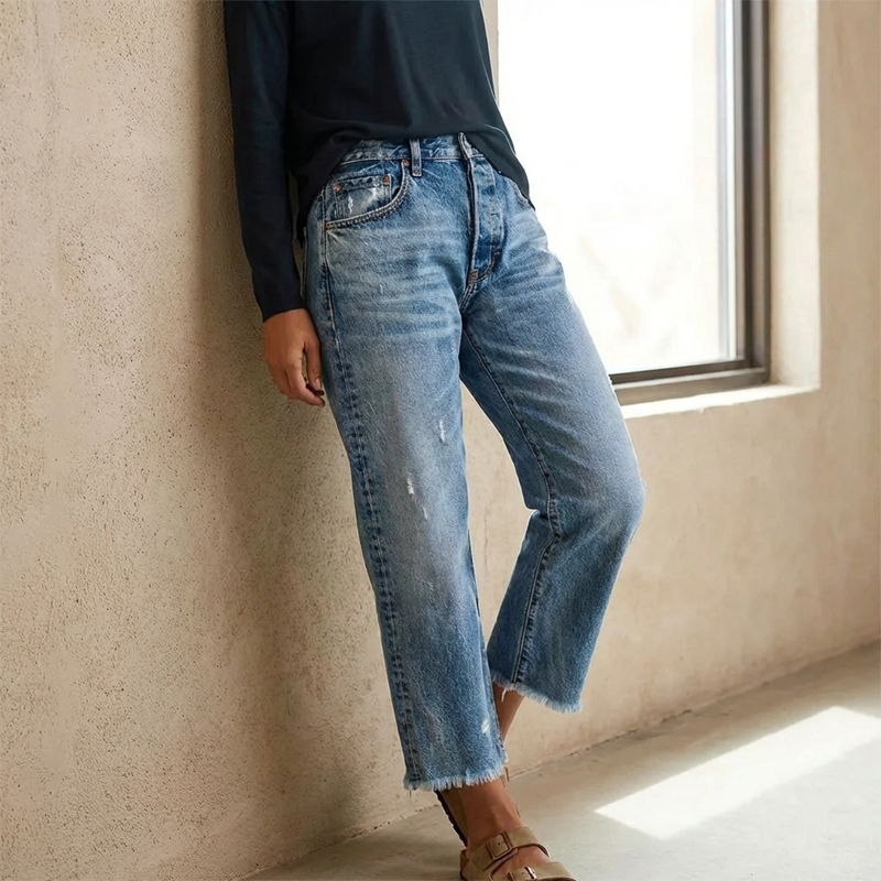 Women's straight leg jeans in classic mid blue with a relaxed silhouette and lightly worn-in detail