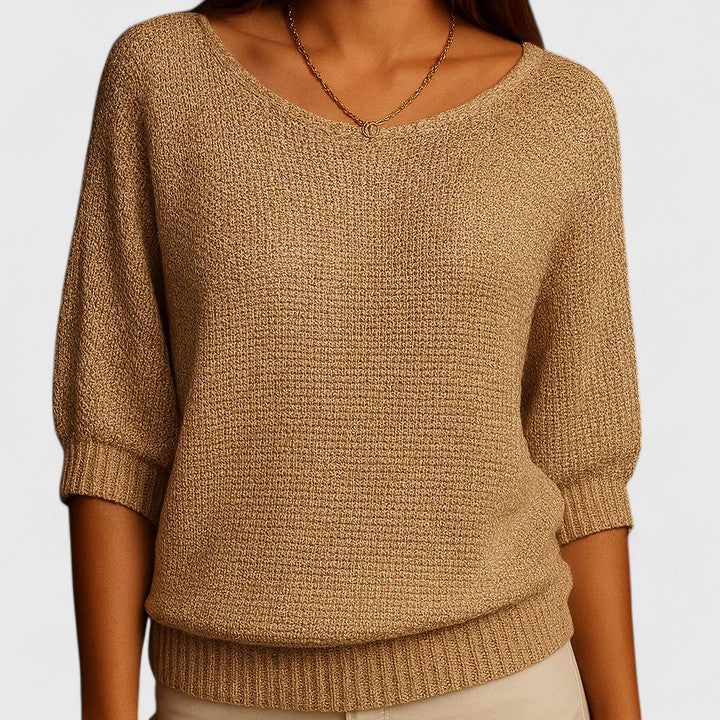 A woman wearing a soft purple jumper with a wide neckline and gently shaped fit.