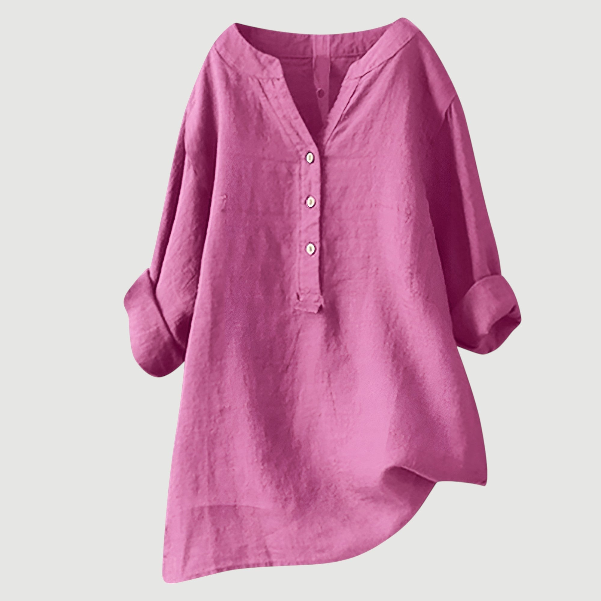 A woman wearing a loose button-front tunic top in white with a relaxed draping fit