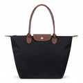 Classic structured tote bag in navy with contrast handles, shown in multiple colours