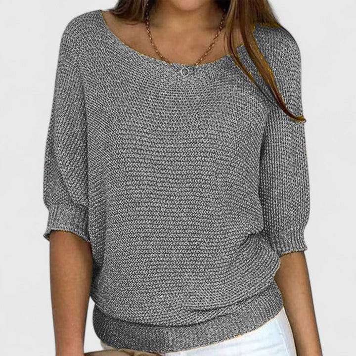 A woman wearing a soft purple jumper with a wide neckline and gently shaped fit.