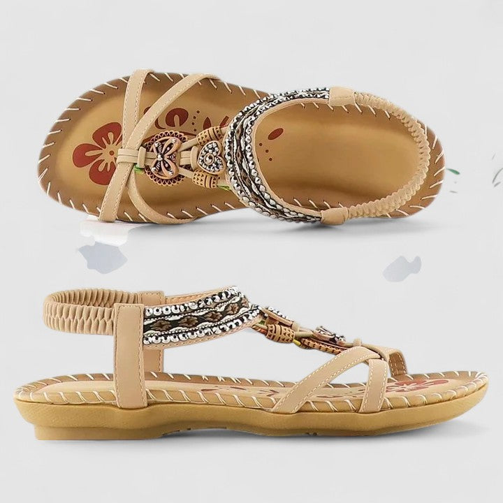 A woman standing comfortably in beige cushioned sandals with adjustable straps and a wide fit.