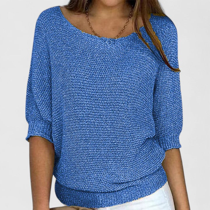 A woman wearing a soft purple jumper with a wide neckline and gently shaped fit.