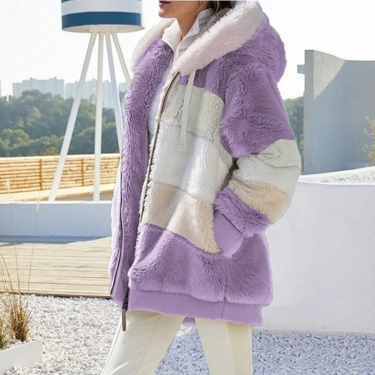 A woman wearing a hooded jacket with side pockets on a cold, rainy day out.
