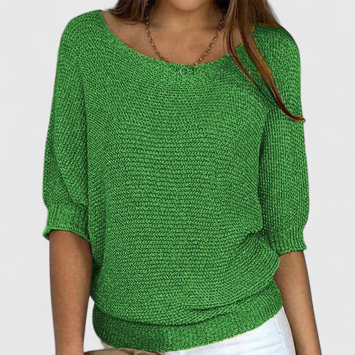 A woman wearing a soft purple jumper with a wide neckline and gently shaped fit.