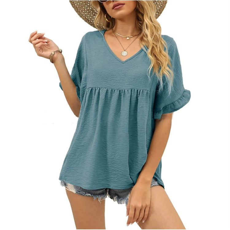 Black relaxed casual top with subtle frill details at the neckline and a flowing summer silhouette