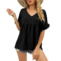 Black relaxed casual top with subtle frill details at the neckline and a flowing summer silhouette