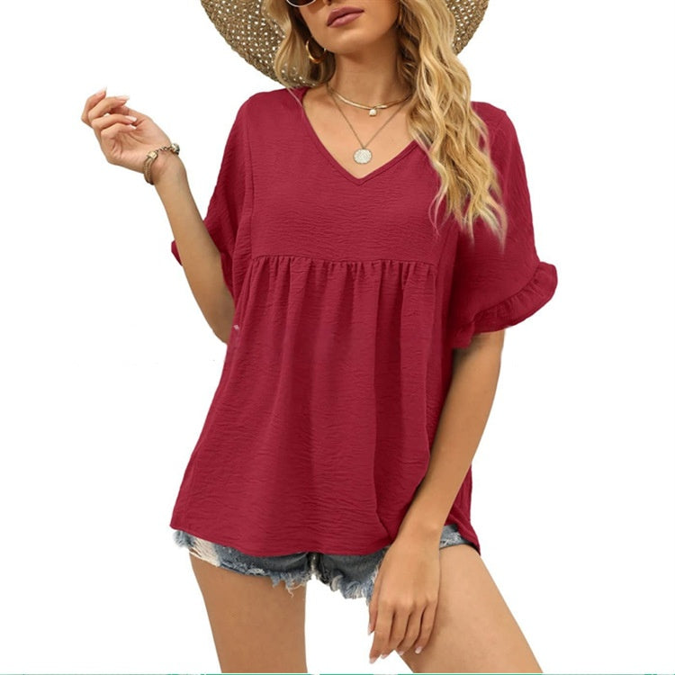 Black relaxed casual top with subtle frill details at the neckline and a flowing summer silhouette