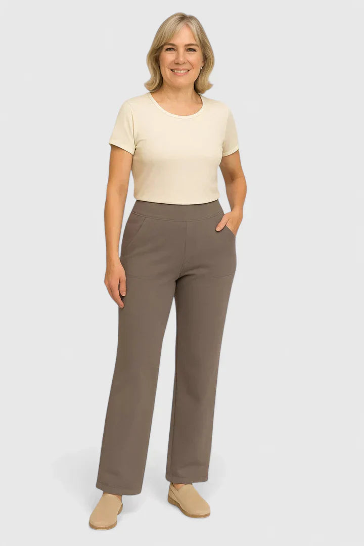 A woman in elegant straight-leg trousers with pockets, styled for a polished everyday look.