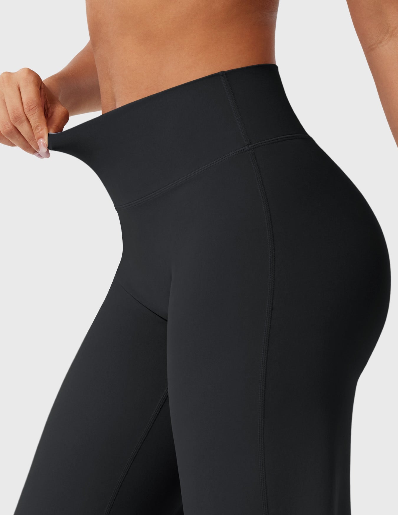 Black high-waisted power flare leggings with a contoured back seam and wide flared leg