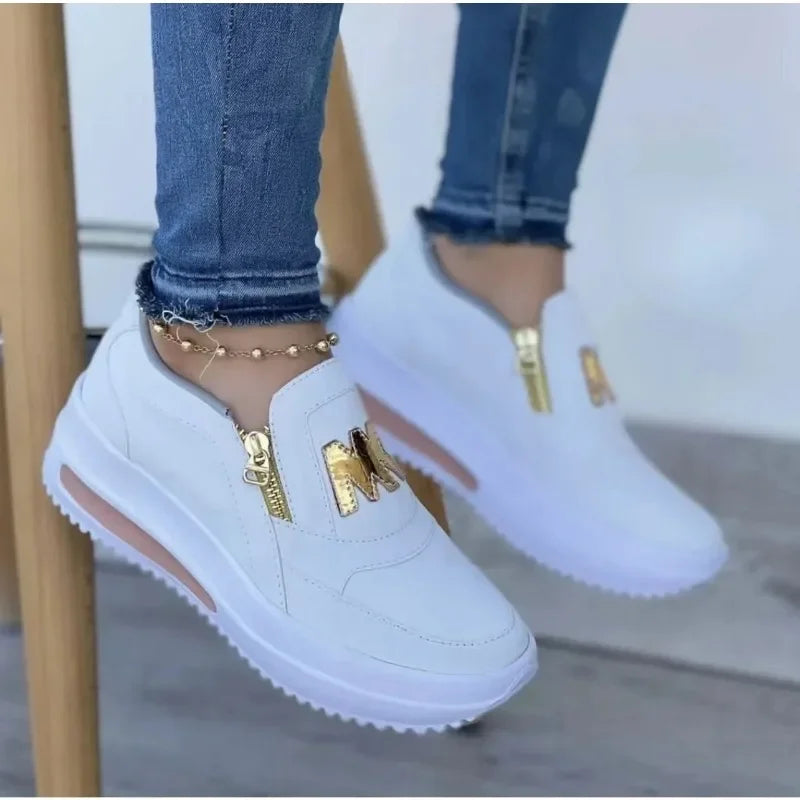 A woman wearing cushioned side-zip trainers with a relaxed everyday outfit